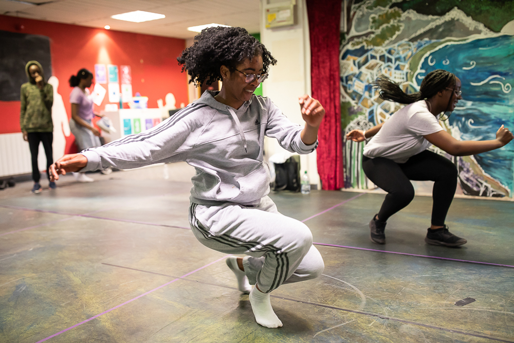 Lotus Youth Dance. A participant wearing a white tracksuit crouches