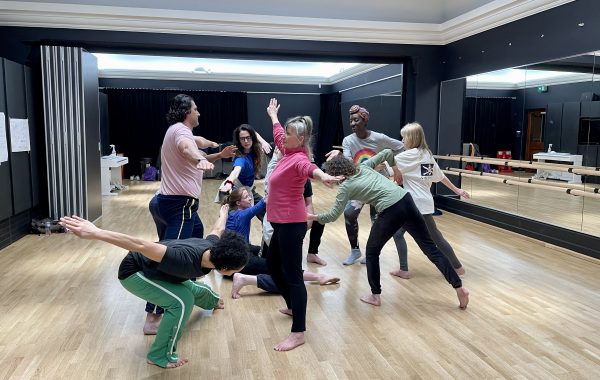 Celebrating 2022. Members of our Adults Performance Company rehearse in a studio with wooden floors and mirrors on the walls