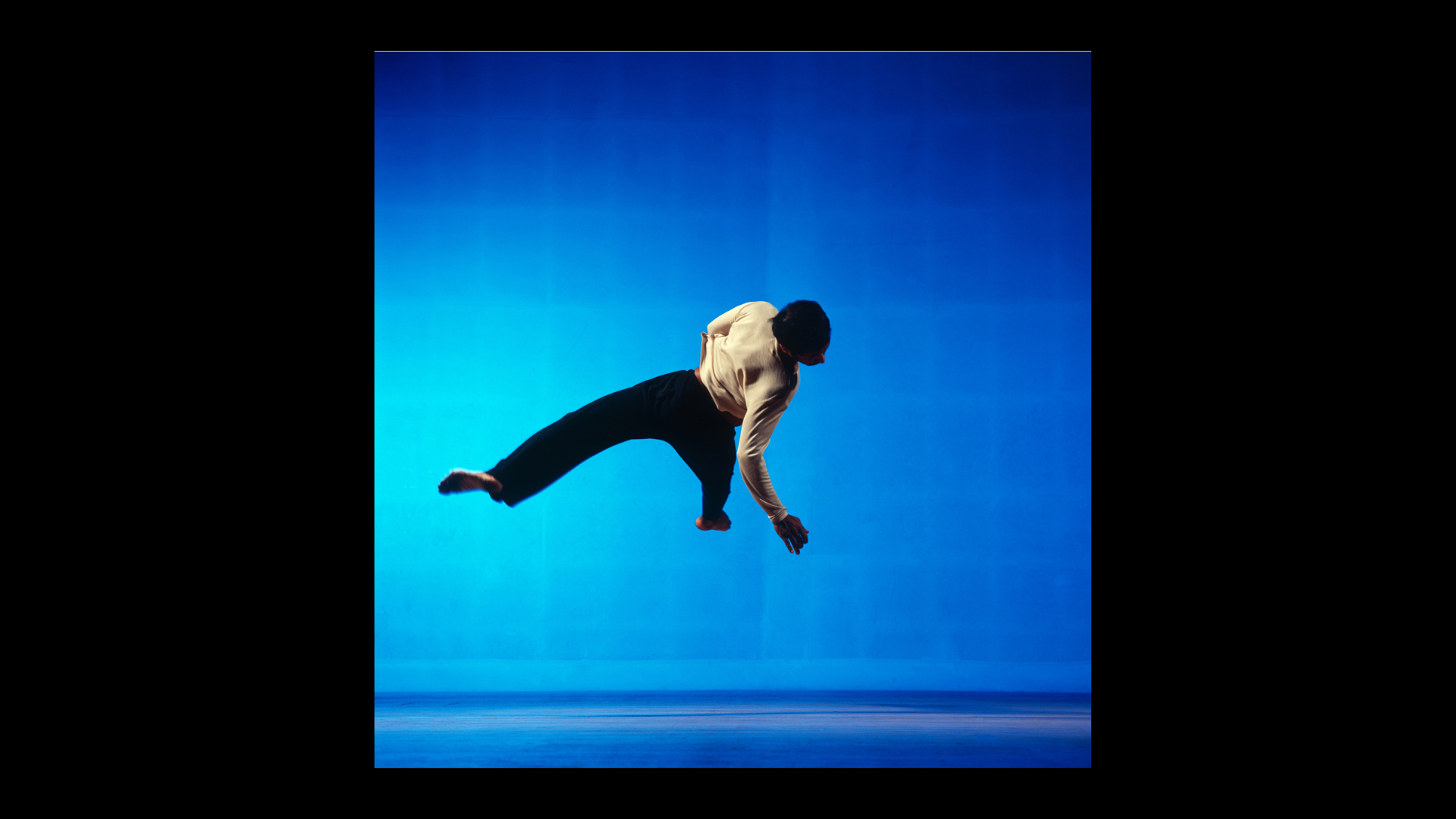 30 years in pictures: Physical Recall and Akram Khan. Dancer Akram Khan leaps into the air, twisting round at the same time.