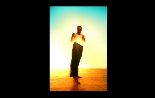 30 years in pictures: Fin Walker & Katherine Markee. A colourful but blurred image of a dancer leaning back and pushing one foot out in front