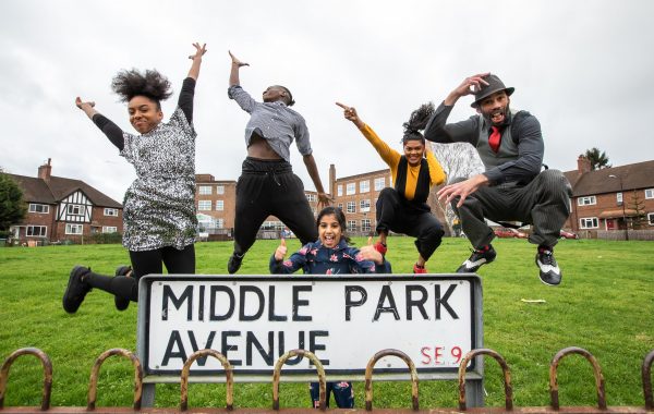 30 years in pictures: Up My Street. Five dancers leap into the air on a village green. In the foreground is a sign that says Middle Park Avenue
