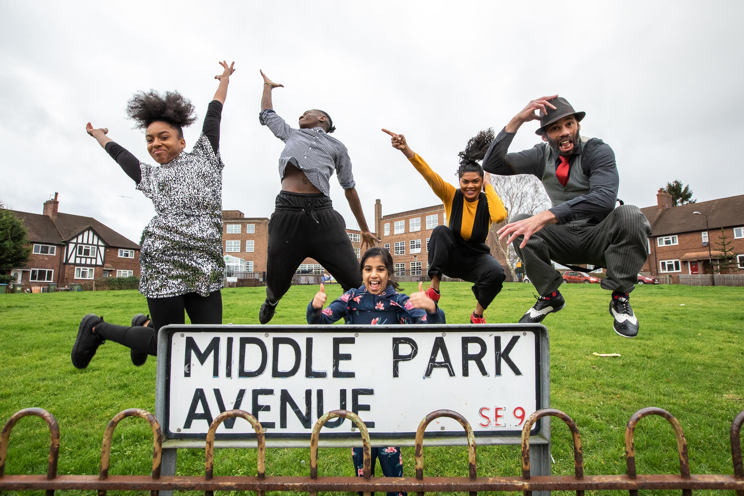 30 years in pictures: Up My Street. Five dancers leap into the air on a village green. In the foreground is a sign that says Middle Park Avenue