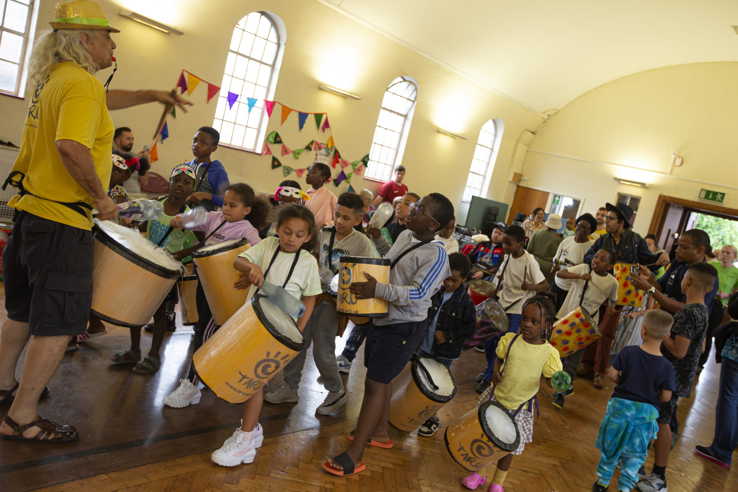 Remembering a glorious Summer in the Park. Children holding home made drums are getting ready to make a lot of noise!