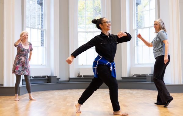 Greenwich Dance transfers grants to keep community projects going. Three smiling dancers move in a studio